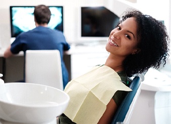 A young woman smiling while in the dentist’s chair